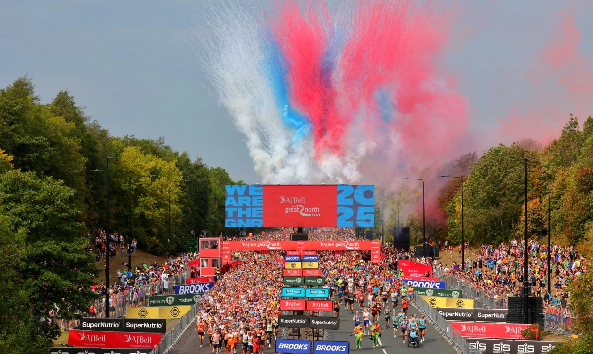 Aerial view of the starting point of the Great North Run. Hundreds of runners and spectators can be seen.