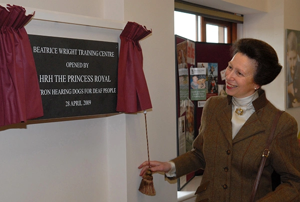 HRH Princess Royal unveiling black wall plaque with white writing at northern training centre in Yorkshire