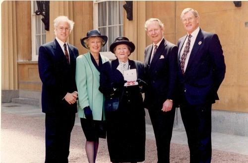 Lady Wright, co-founder, receiving MBE medal pictured with other members of the charity