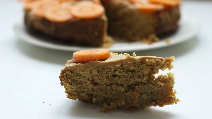 A piece of dog birthday cake with carrots on top